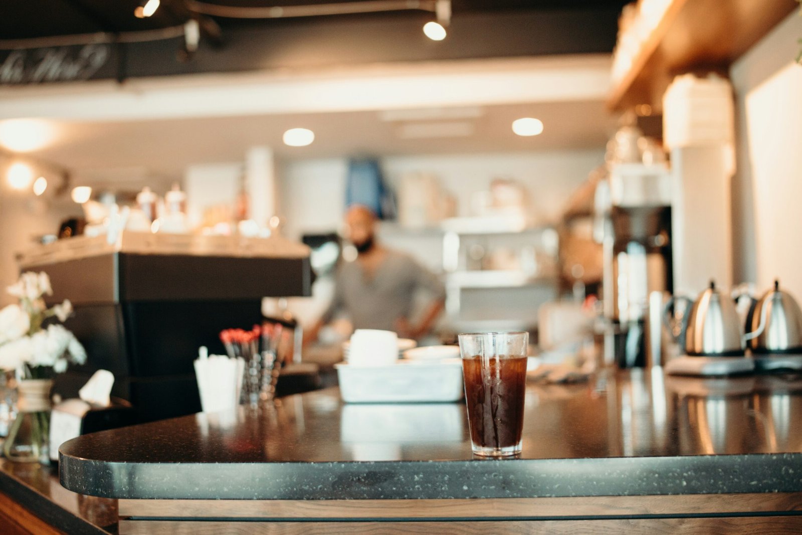 selective focus photography of clear drinking glass filled with black beverage